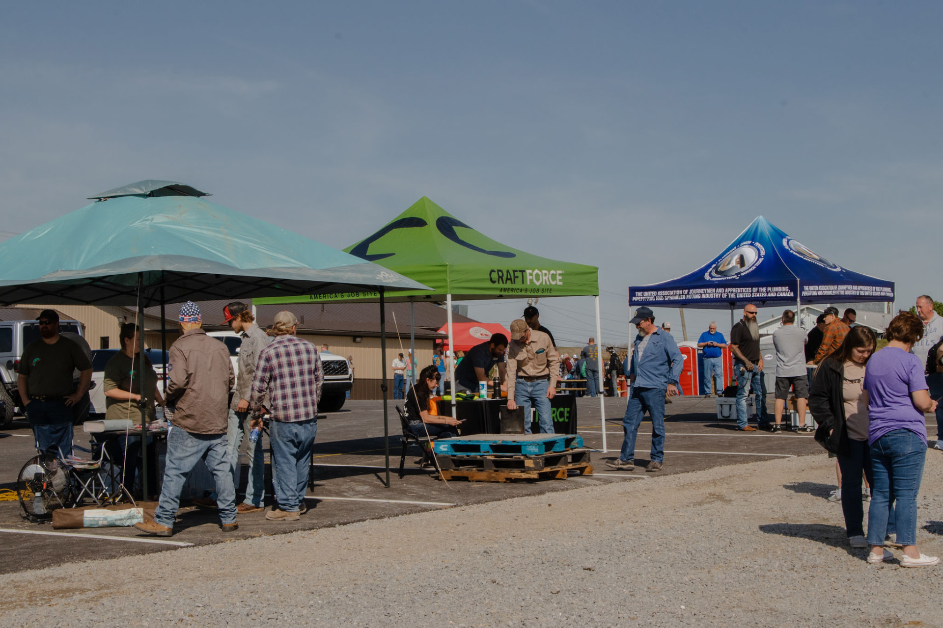 KWI team connecting with employers and future welders at a recruiting booth at an outdoor career fair