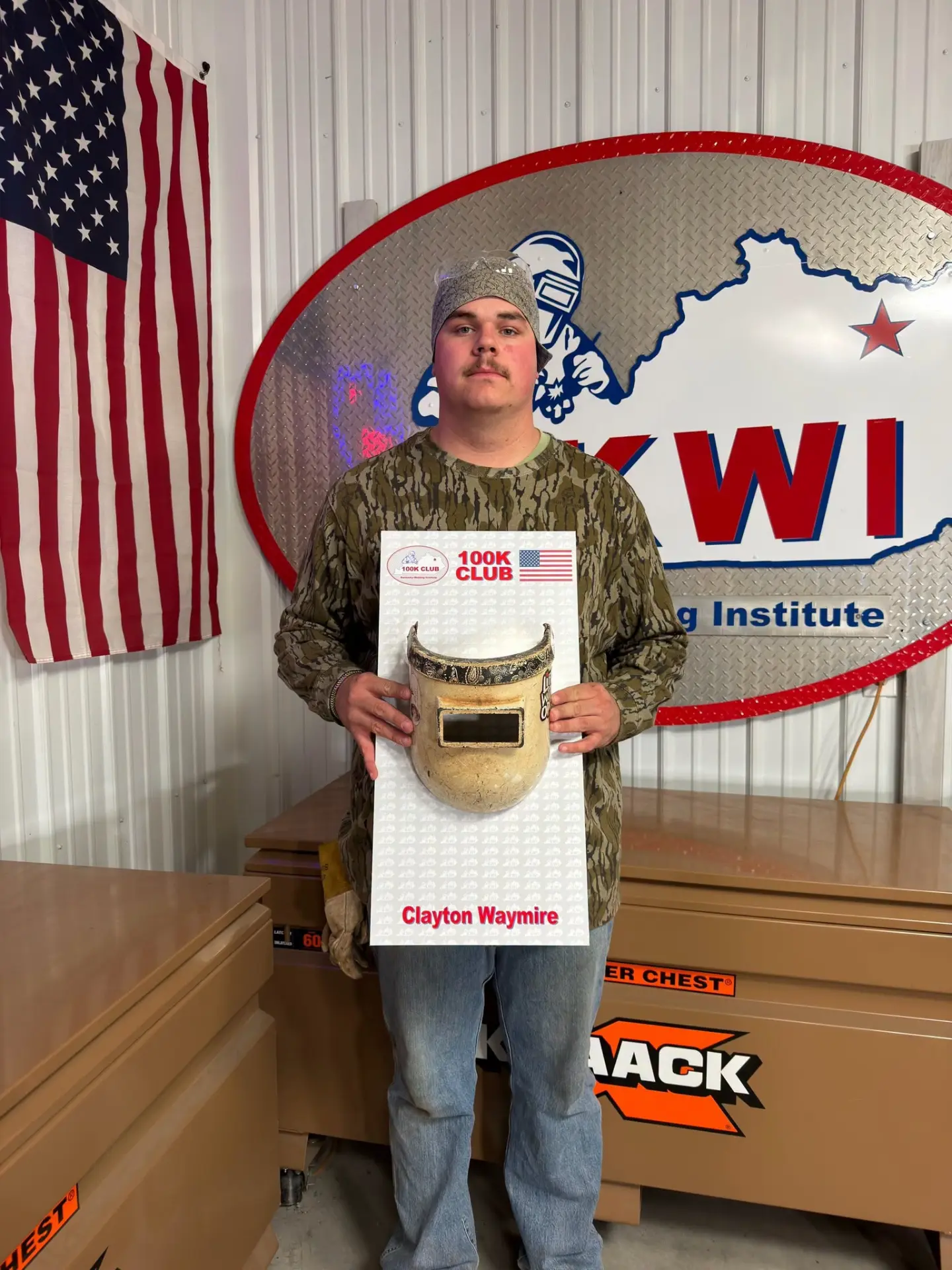 Clayton Waymire, 2025 KWI Graduate from Flemingsburg, Kentucky, holding a KWI 100K Club plaque