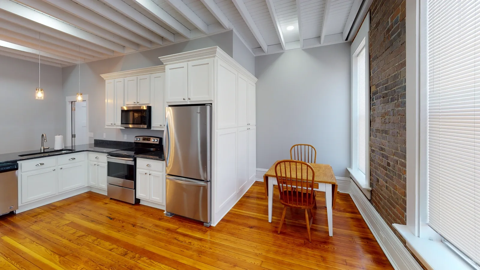 Full kitchen with stove, microwave and refrigerator inside the Cox Building