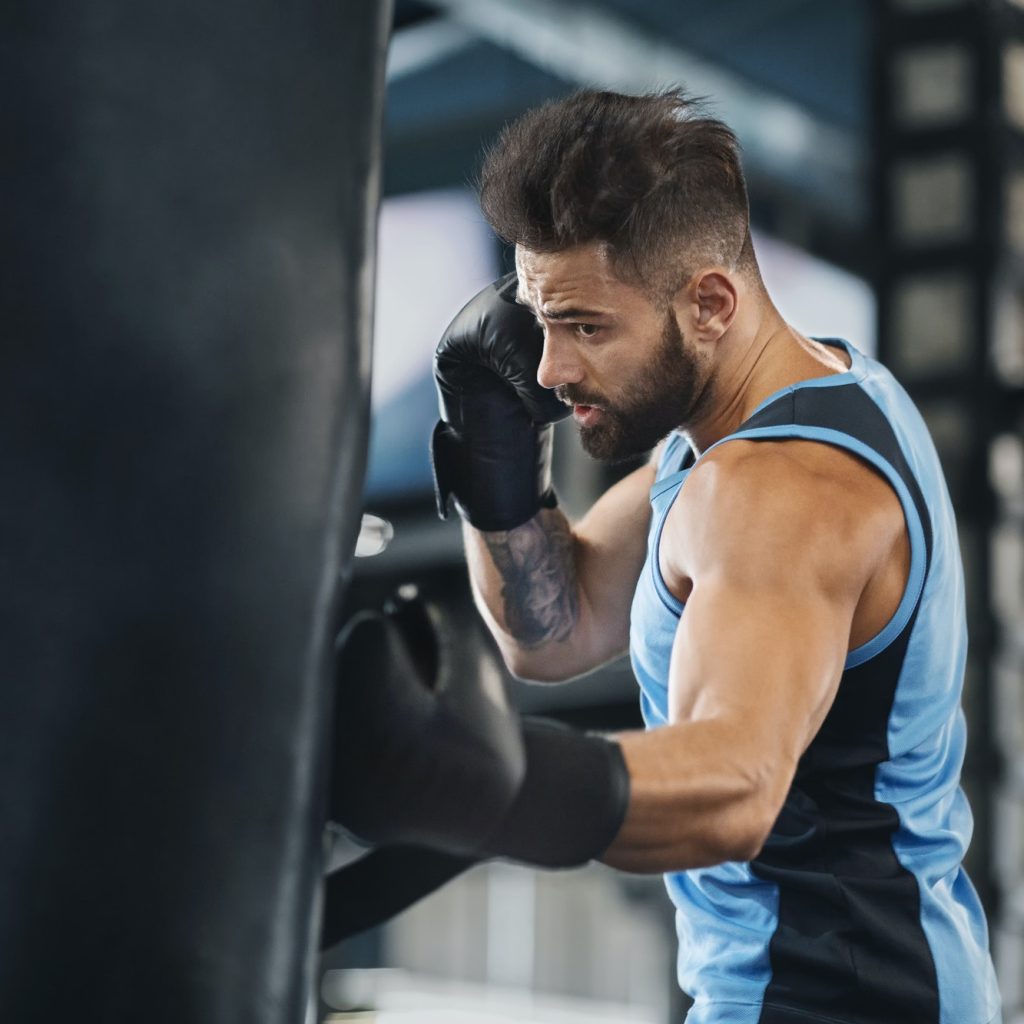 active-guy-punching-boxing-bag-at-gym.jpg